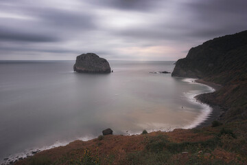Panoramic view of Aketxe Island, Bermeo, from San Juan de Gaztelugatxe on a cloudy day
