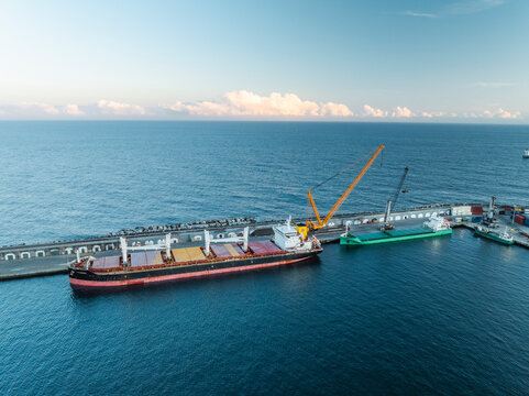Aerial view of cargo ship and crane at port, Ponta Delgada, Azores, Portugal.