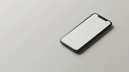 Mobile phone with a white screen lying on a white surface, angled view