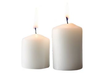 Two lit white candles of different sizes, glowing with a warm flame isolate on transparent background, cutout, png
