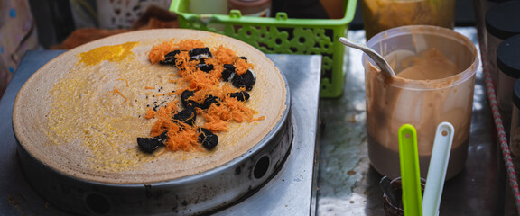 Japanese crepes made from a flat round oven, filled with fillings such as foi thong and raisins. Simplified Thai style desserts. Street food in Bangkok, Thailand.