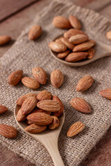 Almond snack fruit in wooden spoon blur background