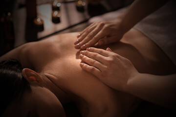 Beautiful young woman lying on table during massage in salon, closeup