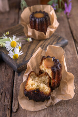 Portion of canele dessert on wooden background