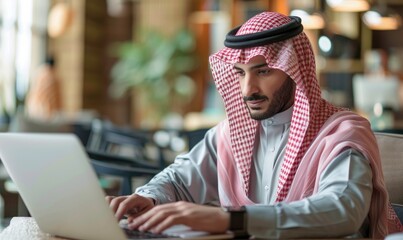 Saudi man is studying on a laptop