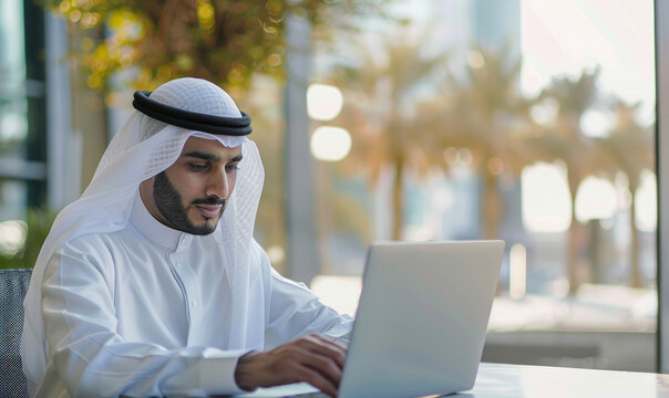 Saudi man is studying on a laptop
