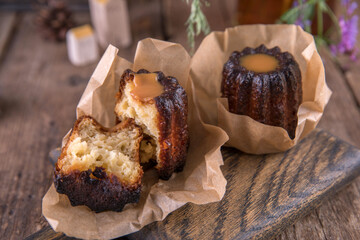 Portion of canele dessert on wooden background
