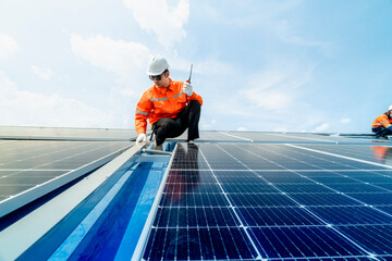 engineer man inspects construction of solar cell panel or photovoltaic cell by electronic device....