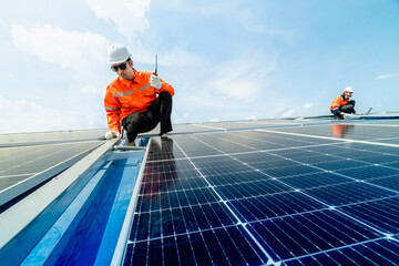 engineer man inspects construction of solar cell panel or photovoltaic cell by electronic device....