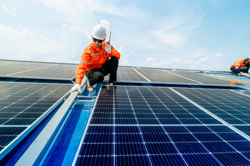 engineer man inspects construction of solar cell panel or photovoltaic cell by electronic device. Industrial Renewable energy of green power. factory worker working on tower roof.