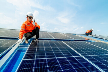 engineer man inspects construction of solar cell panel or photovoltaic cell by electronic device. Industrial Renewable energy of green power. factory worker working on tower roof.