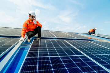 engineer man inspects construction of solar cell panel or photovoltaic cell by electronic device....