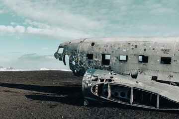 An antique airplane wreck on a dusty field