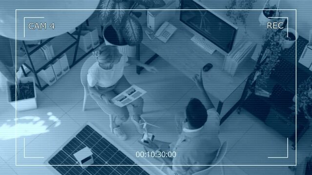 CCTV top view of couple of environmental specialists discussing wind turbines implementation in business