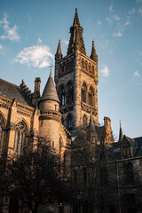 Fototapeta premium A tall building with a clock tower on top, standing majestically against the sky