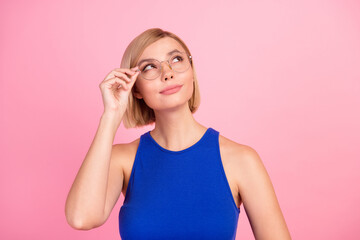Portrait of nice young girl look empty space wear blue top isolated on pink color background