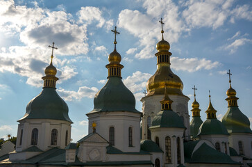 Saint Sophia Cathedral adorned with multiple onion green and gold color domes, each crowned with a delicate cross. Unique monument of architecture and monumental art of the early 11th century. Kyiv