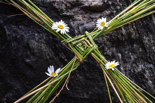 Saint Brigids Cross Irish pagan symbol of house blessing protection from evil and fire. Traditionally made in Ireland on Imbolc first day of Spring St Brigids feast day. On in a rocky background