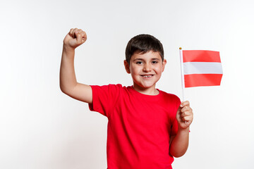 A young boy is holding a Austria flag and smiling