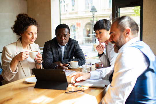 Business meeting in a cafe with diverse professionals