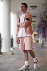 young man posing in fashionable summer style of clothing on street, fashionable young people in trendy clothes