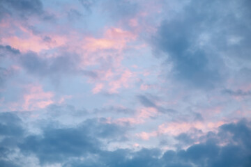 Beautiful clouds in the sky at sunset, pink and blue, natural background, romance, magic