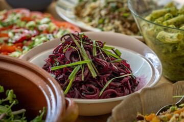 Bettroot salad and other dishes, laid out for a summer buffet