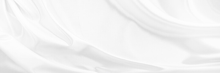 White gray satin texture that is white silver fabric silk panorama background with beautiful soft blur pattern natural.