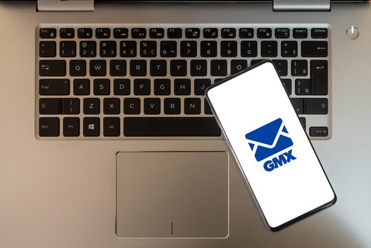 cell phone with the GMX logo on top of the notebook