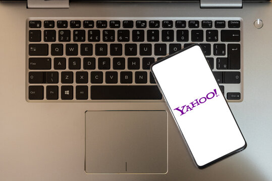 cell phone with the yahoo logo on top of the notebook