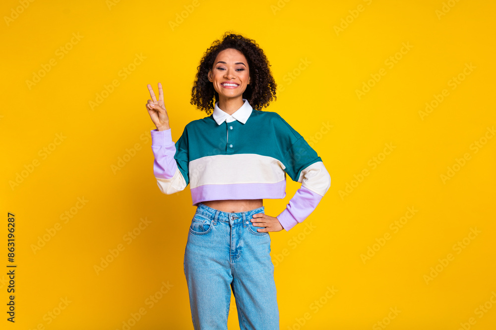 Poster photo of toothy beaming woman with perming coiffure dressed stylish shirt show v-sign hand on waist 