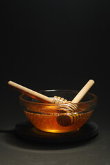 Yellow liquid honey dripping from the honey spoon	