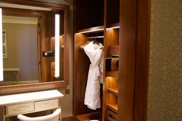 RAS AL KHAIMAH, UNITED ARAB EMIRATES - JUN 11, 2019: Walk-in closet with white bathrobe in the closet in a luxurious hotel room in a five-star hotel