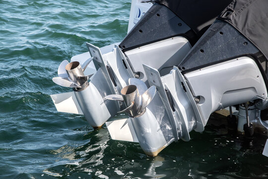 Outboard engine propeller on motorboat closeup on sea waters background