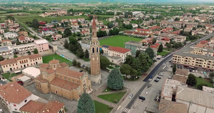 Aerial view of the cityscape of Cornuda, Italy. A beautiful historic cathedral on the central square of the village. High quality 4k footage