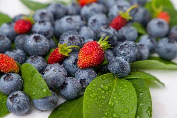 Blueberries and strawberries, close up view.