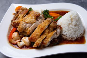 Asian fried tofu with vegetables, duck and rice served on table 
