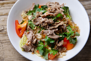 Asian salad with beef and fresh vegetables on plate 
