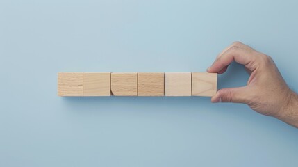 Reaching New Heights Hand Placing Wooden Block in Progress Bar 75 Completion Motivational Concept for Goal Achievement on Light Blue Background