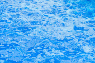 Blue vibrant foamy liquid waves. Abstract colored water