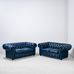 pair of blue sofas in empty room