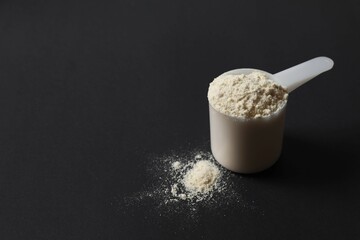 Spoon with protein on black background
