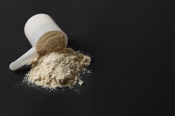 Spoon with protein on black background