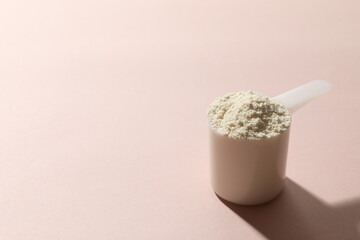 Spoon with protein on colored background