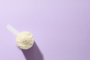 Spoon with protein on colored background