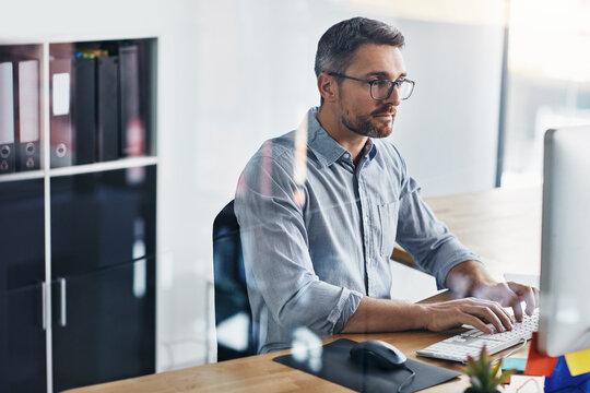 Clerk, computer and business man typing at desk for project proposal, update report or folders. Admin, professional and employee with keyboard for planning, agenda or review portfolio in office - Powered by Adobe