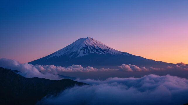 A majestic mountain peak with snow capped summit, rising above a sea of clouds at sunrise.