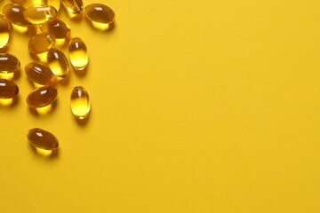 Omega-3 capsules on color background with copyspace. Healthcare, wellbeing and supplements.