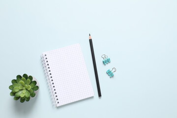 Flat lay with pencil and notebook on color  background