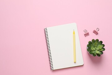 Flat lay with pen and notebook on color  background